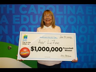 NCEL Photo  - Ann LaFave holds the ceremonial $1 million 